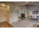 Open living room featuring neutral paint, plush carpet, and a mounted TV on a gray stand at 930 N Mesa Dr # 2073, Mesa, AZ 85201