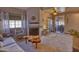 Spacious living room with a cozy fireplace, unique wood coffee table, and lots of natural light at 930 N Mesa Dr # 2073, Mesa, AZ 85201