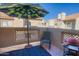 Balcony featuring an umbrella, chair, and grill, with an open view of surrounding buildings at 930 N Mesa Dr # 2073, Mesa, AZ 85201
