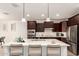 Kitchen island with white countertop and seating for four at 112 E Tonto Pl, Chandler, AZ 85249