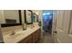 Bathroom with double sinks, wood cabinets, a framed mirror and a separate shower and toilet room at 11232 N 152Nd Ln, Surprise, AZ 85379