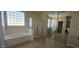 Bright bathroom featuring a soaking tub, glass-enclosed shower, and mirrored closet at 11232 N 152Nd Ln, Surprise, AZ 85379