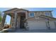 A two-story home with a three-car garage and stone accents, situated on a well-maintained lot at 11232 N 152Nd Ln, Surprise, AZ 85379