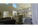 Spacious living room with high ceilings, a piano, and a staircase leading to the upper level at 11232 N 152Nd Ln, Surprise, AZ 85379