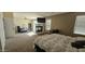 Spacious main bedroom featuring a fireplace, TV, and adjacent office space with plenty of natural light at 11232 N 152Nd Ln, Surprise, AZ 85379