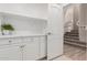 Bright laundry room with white cabinets and shelving at 14026 S 34Th St, Phoenix, AZ 85044