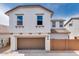 Charming two-story home featuring an attached garage, neutral color palette and desert landscaping at 14670 W Sand Hills Rd, Surprise, AZ 85387