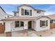 Inviting two-story home with a covered porch, brown shutters, and low maintenance desert landscaping at 14670 W Sand Hills Rd, Surprise, AZ 85387