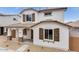 Charming two-story home showcasing neutral exterior paint, brown shutters, and a well-manicured front yard at 14670 W Sand Hills Rd, Surprise, AZ 85387