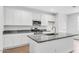 Bright kitchen with granite countertops, white cabinetry, and stainless steel appliances at 14670 W Sand Hills Rd, Surprise, AZ 85387