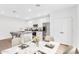 Bright kitchen features stainless steel appliances, granite countertops, and a dining area with a marble table at 14670 W Sand Hills Rd, Surprise, AZ 85387