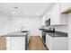Modern kitchen with stainless steel appliances, granite countertops, a central island, and recessed lighting at 14670 W Sand Hills Rd, Surprise, AZ 85387