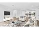 Bright, open concept living room with stylish decor flowing into a modern kitchen for seamless entertaining at 14670 W Sand Hills Rd, Surprise, AZ 85387