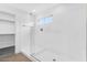 Modern glass shower with white walls and tile, and window for natural light at 14670 W Sand Hills Rd, Surprise, AZ 85387