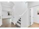 Bright entryway featuring a staircase with carpeted steps and wood flooring at 14670 W Sand Hills Rd, Surprise, AZ 85387