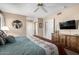 Primary bedroom with large TV, dresser, and closet at 14818 N 103Rd Ave, Sun City, AZ 85351