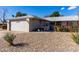 House exterior with a two-car garage and rock landscaping at 14818 N 103Rd Ave, Sun City, AZ 85351