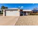 Single-story home with attached garage and landscaped front yard at 14818 N 103Rd Ave, Sun City, AZ 85351