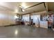 Garage with ample storage cabinets and space for tools at 14818 N 103Rd Ave, Sun City, AZ 85351