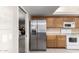 Efficient kitchen with stainless steel refrigerator and ample counter space at 14818 N 103Rd Ave, Sun City, AZ 85351
