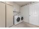 Laundry room with washer, dryer, cabinets, and extra storage at 14818 N 103Rd Ave, Sun City, AZ 85351