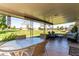 Covered patio with seating area and view of grassy yard at 14818 N 103Rd Ave, Sun City, AZ 85351