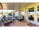 Covered patio features seating area and access to the yard at 14818 N 103Rd Ave, Sun City, AZ 85351