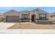 Charming single-story home featuring a neutral color palette, a two-car garage, and a low-maintenance front yard at 1561 E Mason Dr, Casa Grande, AZ 85122