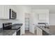 Well-equipped kitchen with stainless steel appliances, granite countertops, and a convenient pantry at 1561 E Mason Dr, Casa Grande, AZ 85122