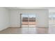 Open living space with tile flooring, and a sliding glass door that brings in natural light and views of the backyard at 1561 E Mason Dr, Casa Grande, AZ 85122
