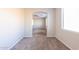 Carpeted hallway with archways leading to bedrooms at 15930 W Redfield Rd, Surprise, AZ 85379