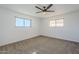 Spacious bedroom with neutral carpeting and ceiling fan at 1675 N Monterey Dr, Apache Junction, AZ 85120