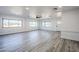 Bright and airy living room with wood-look floors and ceiling fan at 1675 N Monterey Dr, Apache Junction, AZ 85120