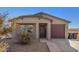 Single-story house with a brown garage door and landscaped front yard at 175 Arkin Cir, Morristown, AZ 85342