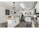 Modern kitchen with white cabinets, a kitchen island, and stainless steel appliances at 175 Arkin Cir, Morristown, AZ 85342