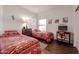 Bedroom with two twin beds, workspace, and wood floors at 17561 N Saddle Ridge Dr, Surprise, AZ 85374