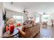 Open living room and dining area with hardwood floors and ceiling fan at 17561 N Saddle Ridge Dr, Surprise, AZ 85374
