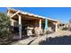 Relaxing patio with rocking chairs and umbrella at 17561 N Saddle Ridge Dr, Surprise, AZ 85374