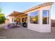 Covered patio, dining area, and view of the backyard at 17824 W Addie Ln, Surprise, AZ 85374
