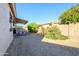 Landscaped backyard with gravel and mature plants at 17824 W Addie Ln, Surprise, AZ 85374