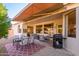 Covered patio with seating area, dining table, and grill at 17824 W Addie Ln, Surprise, AZ 85374