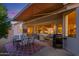 Covered patio with seating area, dining table, and grill at 17824 W Addie Ln, Surprise, AZ 85374