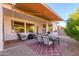 Relaxing patio features seating, dining table, and shade at 17824 W Addie Ln, Surprise, AZ 85374