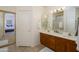 Bathroom with double sinks, a large mirror, and a separate shower at 17824 W Addie Ln, Surprise, AZ 85374