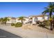 Single-story home with inviting front yard, palm trees, and a two-car garage at 17824 W Addie Ln, Surprise, AZ 85374