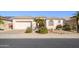Single-story home with neutral exterior, landscaping, and a two-car garage at 17824 W Addie Ln, Surprise, AZ 85374