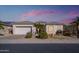 Single-story home with neutral exterior, landscaping, and a two-car garage at 17824 W Addie Ln, Surprise, AZ 85374