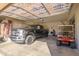 Spacious garage with a Ford truck, golf cart, and overhead storage at 17824 W Addie Ln, Surprise, AZ 85374