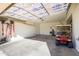 Garage with golf cart, storage, and overhead door at 17824 W Addie Ln, Surprise, AZ 85374