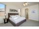 Main bedroom with king bed and ensuite bathroom at 17824 W Addie Ln, Surprise, AZ 85374